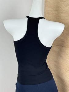 Detail view of racerback design on a black slim fit ribbed knit tank top for women