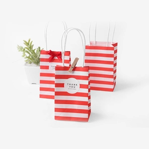 Mini red and white striped paper gift bags with handles and decorative bow accessories