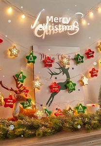 Close-up of star-shaped Christmas LED string lights with warm yellow festive glow