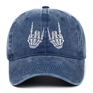 Detail of vintage washed cotton baseball cap with skull hand bone embroidery decoration