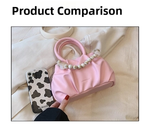 Detail of pink pleated PU leather cloud bag featuring an elegant pearl bead handle