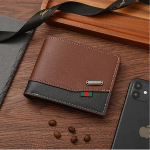 Detail of bifold wallet on wood table showing contrast stitching and striped webbing