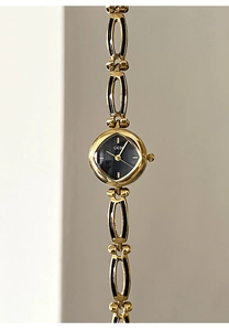 Detail of GEDI gold alloy bracelet watch with oval links and black dial for women