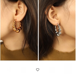 Exaggerated geometric hoop earrings with gradient beads in gold and silver metal finishes