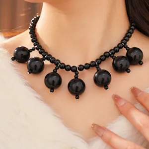 Elegant black acrylic beaded necklace with large spherical tassels for luxury fashion style