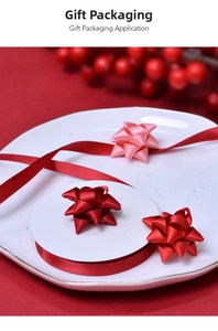 Macro shot of 9mm red satin ribbons and handmade star bows for gift box packaging