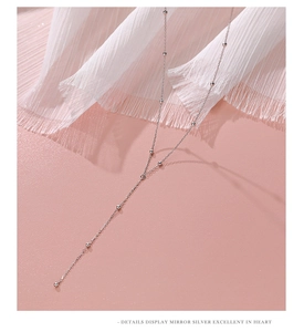 Detailed view of the S925 sterling silver tassel chain with small silver beads on pink