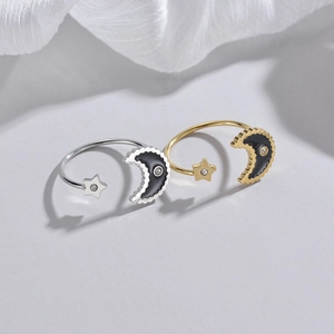 Adjustable 14K gold and silver celestial rings with black enamel moon and star charms
