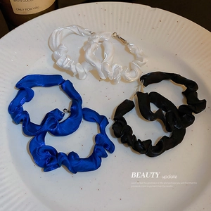 Chic hoop earrings featuring glossy pleated fabric in white, blue, and black colors