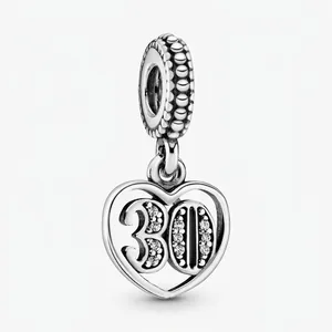 Detailed close-up of a silver number 30 heart charm with sparkling pavé zircons