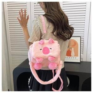 Pink plush Capybara bag shown on model with adjustable strap and chain detail