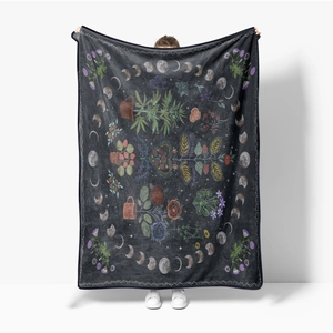 Detail of floral and moon phase patterns on soft black flannel fleece blanket