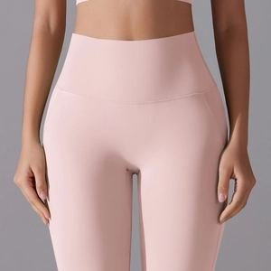 Close-up of pink high-waisted yoga pants with elastic waistband and seamless stitching