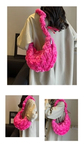 Detailed close-up of pink quilted cloud bag with textured pleats and soft fabric finish