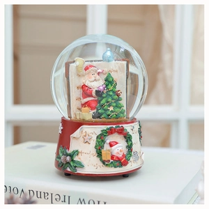 Detailed view of a Christmas snow globe with Santa Claus inside on a red resin base