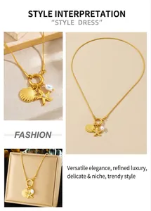 Detail view of a gold ocean necklace with shell, starfish charm and white pearl