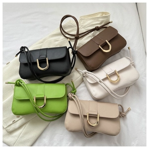 Top view of five colorful minimalist underarm bags with U-shaped gold hardware details