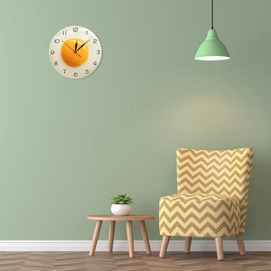 Detail of creative fried egg wall clock hanging on a soft green modern living room wall