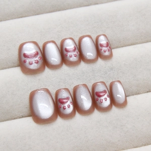 Handmade cat eye press-on nails with cute pink cat paw art and silver shimmer finish