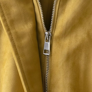Mustard yellow suede bomber jacket featuring a detailed silver metal zipper closure