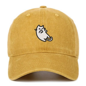 Detailed view of the cat embroidery on a washed vintage yellow cotton baseball cap