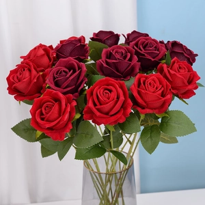 Velvet artificial red roses in a glass vase for home decor and wedding arrangement
