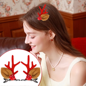 Detail of cute plush Christmas reindeer antler hair clips with red and brown accents