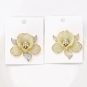 Detail of flower brooches with micro-pave cubic zirconia on gold and silver petals