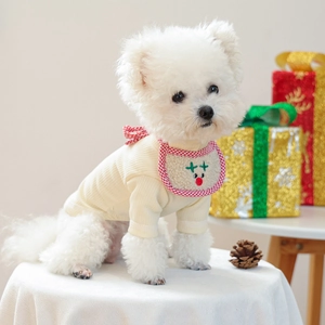 Detail of knitted pet beige sweater and red plaid reindeer bib for Christmas