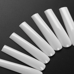 Close-up of long coffin false nails in natural milky white with a glossy finish