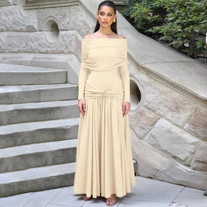Detail of off-shoulder pleated maxi dress featuring a twisted knot waist design in apricot