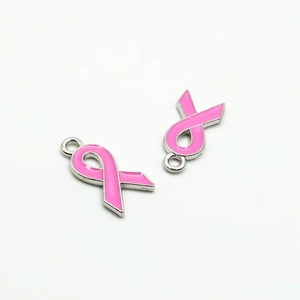 Close-up of pink enamel ribbon pendants with silver frames for DIY jewelry making