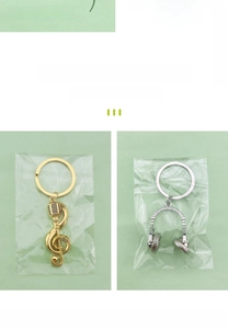 Detail of music theme keychains featuring a rotating headphone and golden musical note
