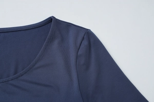 Detailed close-up of U-neckline and shoulder stitching on a navy short sleeve dress