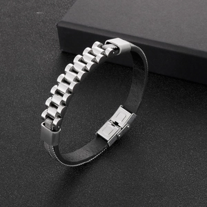 Detail of men's leather and stainless steel bracelet with watch buckle on dark background