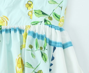 Detail of lemon print poplin dress with mint green fabric and striped waist belt