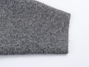 Macro view of grey knit fabric texture and high-quality cuff stitching on the casual coat