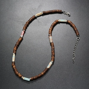 Detail of ethnic necklace with brown coconut beads, colorful stones and metal lobster clasp