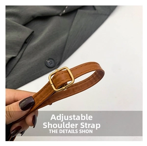 Detail of adjustable brown leather shoulder strap with gold buckle on leopard bag