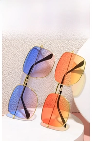 Macro view of square oversized metal sunglasses with blue-purple and orange gradient lenses