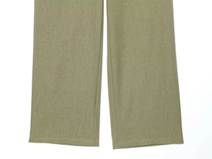 Detailed macro view of woven army green wide-leg trousers showing neat hem and stitching