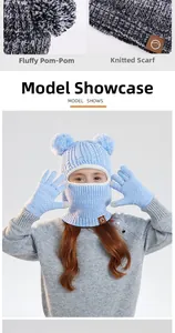 Detail of children's knit winter balaclava set with pom-poms and matching gloves