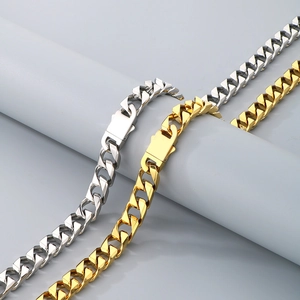 Detailed view of 13mm gold and silver Cuban link bracelets with heavy metal texture