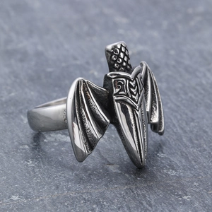 Gothic bat wing sword ring in vintage steel finish on a natural stone background