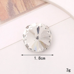Detail view of a 1.8cm round glass crystal with silver claw setting and 3g weight