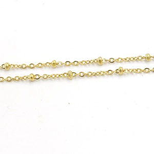 Macro shot of parallel gold stainless steel bead satellite chains with smooth texture