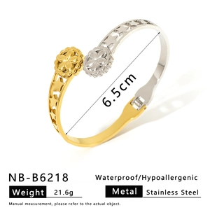 Detailed view of bicolor stainless steel bangle featuring hollow flower and star designs