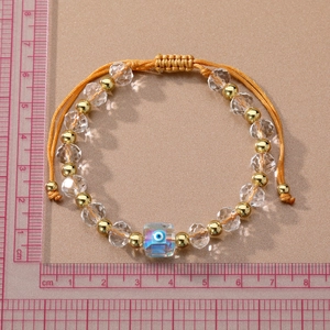 Minimalist evil eye crystal beaded bracelet with adjustable yellow cord on ruler