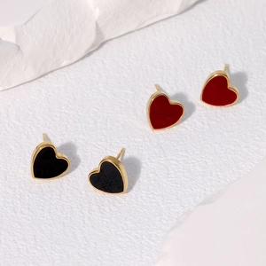Detailed view of red and black heart stud earrings with polished gold-plated edges