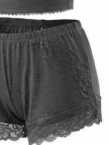 Detail of grey lace trim shorts with elegant floral lace pattern and soft fabric